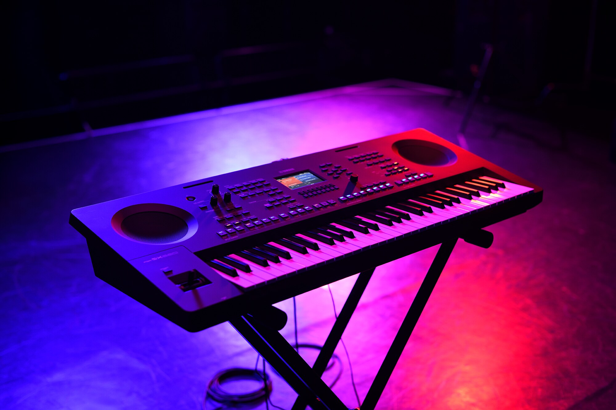 A keyboard on a stand under stage lighting